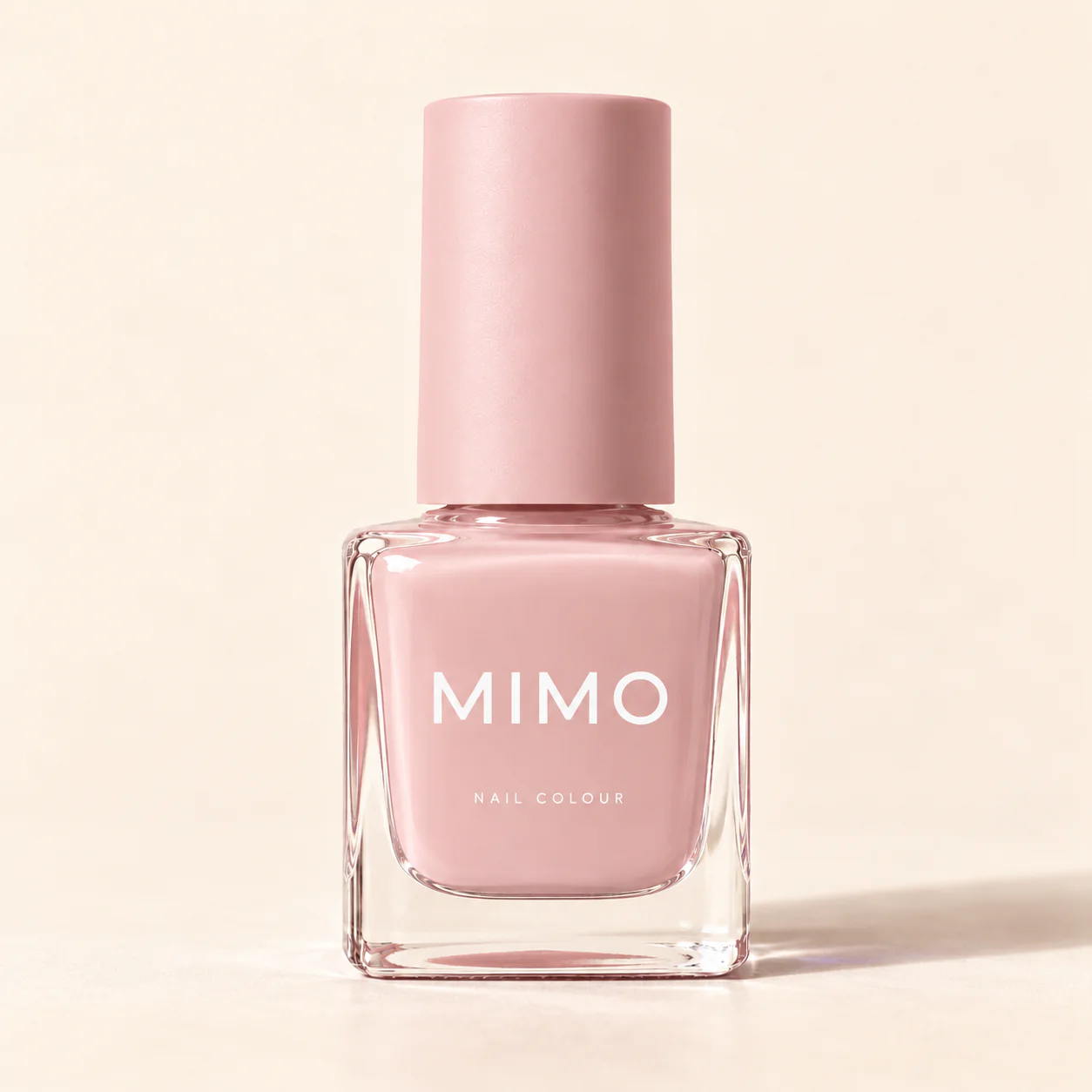 สีทาเล็บ MIMO สีชมพูบลัช ขวดแก้วทรงเหลี่ยม ฝาสีเดียวกัน บนพื้นสีครีม